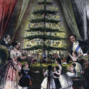 A picture of a family surrounding the Christmas tree