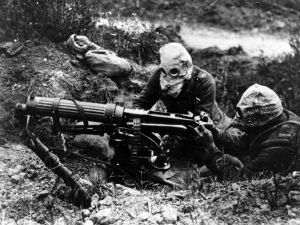 A picture of Gas-masked troops of the British Machine Gun Corps with a Vickers machine gun.