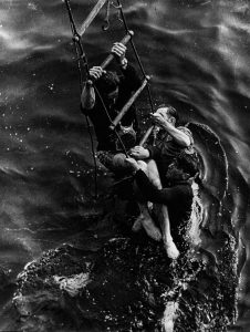 A picture of troops climbing aboard a vessel -Dunkirk Evacuation