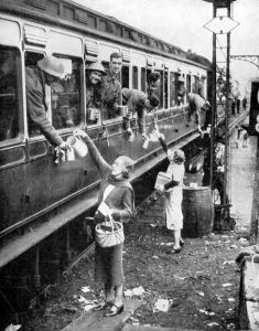 A picture of locals giving refreshments to soldiers