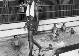 An image of David Isom walking into a pool full of whites